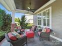Inviting covered porch features cozy seating with a ceiling fan and tiled flooring at 3007 Arsdale Rd, Waxhaw, NC 28173