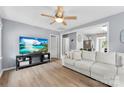 Inviting living room boasts hardwood floors, light gray walls, a ceiling fan, and a comfortable sofa at 310 S Jacob St, Cherryville, NC 28021