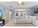 Bright living room showcasing hardwood floors, a neutral sofa, and an open layout to the kitchen at 310 S Jacob St, Cherryville, NC 28021
