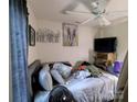 Bedroom with ceiling fan, artwork, and neutral wall color at 3241 Reid Ave, Charlotte, NC 28208