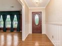 Elegant foyer with hardwood floors, chandelier, and decorative wall trim at 3408 Oak Tree Trl, Matthews, NC 28105