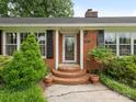 Inviting front entrance with decorative door, brick steps and lush greenery at 3408 Oak Tree Trl, Matthews, NC 28105
