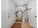 Inviting entryway featuring hardwood floors, a staircase with wooden banister, and a unique cat climber at 3702 Brookstone Trl, Indian Trail, NC 28079