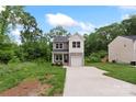 Charming two-story home featuring a gray and white exterior, attached garage, long driveway, and lawn at 510 3Rd St, Salisbury, NC 28144