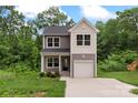 Charming two-story home featuring a gray and white exterior, attached garage and well-maintained landscaping at 510 3Rd St, Salisbury, NC 28144