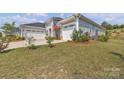 Eye-level view of home showing well-maintained landscaping and three-car garage at 513 Meadow Ridge Dr, Belmont, NC 28012