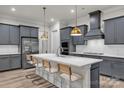Stylish kitchen with stainless steel appliances, gray cabinets, island with pendant lighting, and tile backsplash at 513 Meadow Ridge Dr, Belmont, NC 28012
