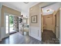 Spacious foyer with hardwood flooring, elegant trim, and a view into the living area at 5424 Tilley Manor Dr, Matthews, NC 28105