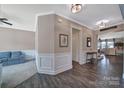Bright hallway with hardwood floors, decorative molding, and an inviting open layout at 5424 Tilley Manor Dr, Matthews, NC 28105