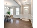 Elegant foyer featuring hardwood floors, wainscoting, and a welcoming front door at 5635 Agora Ct, Lancaster, SC 29720