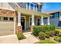 Inviting front porch features stone accents and classic columns, enhancing curb appeal at 5635 Agora Ct, Lancaster, SC 29720
