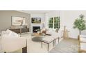 Bright living room featuring a fireplace, modern decor, a large window, and stylish furnishings at 660 14Th Avenue Ne Ct, Hickory, NC 28601