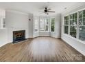 Bright living room featuring a fireplace and large windows offering ample natural light at 7130 Founders Club Ct, Charlotte, NC 28269