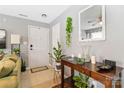 Inviting entryway featuring a console table with decorative accents and plants at 1108 Plaza Walk Dr, Charlotte, NC 28215