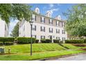 Beautiful exterior of a multi-story home with manicured lawn and mature trees at 1108 Plaza Walk Dr, Charlotte, NC 28215