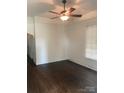 Cozy room featuring hardwood floors, white trim, and a vintage ceiling fan fixture at 1126 Clement Ave, Charlotte, NC 28205
