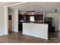 Open kitchen with dark cabinets, granite counters, and a breakfast bar at 1201 Forest Ridge Rd, Bessemer City, NC 28016
