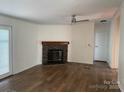 Spacious living room with a stone fireplace and modern ceiling fan at 1201 Forest Ridge Rd, Bessemer City, NC 28016