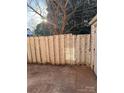 Fenced backyard with concrete patio and mature tree offering shade at 1228 Archdale Dr # G, Charlotte, NC 28217