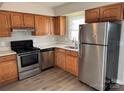 Well-lit kitchen features stainless steel appliances, light countertops, and wood cabinets at 1228 Archdale Dr # G, Charlotte, NC 28217