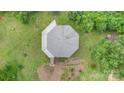 Overhead shot of the octagonal home on a grassy lot surrounded by trees and meticulous landscaping at 147 Buck And Doe Ln, Statesville, NC 28625
