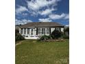 The home's lush backyard features a concrete patio and beautiful landscaping at 15116 Legend Oaks Ct, Fort Mill, SC 29707