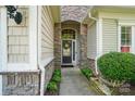 Inviting front entrance with stone accents and a decorative wreath welcoming you home at 15116 Legend Oaks Ct, Fort Mill, SC 29707