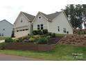 Charming home featuring a well-manicured lawn, beautiful landscaping and a two car garage at 15250 Windward Ln, Lancaster, SC 29720