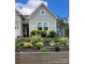 A charming two-story home with beautiful front yard landscaping and a cozy porch at 15250 Windward Ln, Lancaster, SC 29720