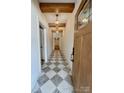 Welcoming home entryway featuring decorative tile floor, wood door, beams, and modern light fixtures at 1721 S New Hope Rd, Gastonia, NC 28054