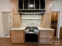 Modern kitchen featuring stainless steel appliances, custom cabinets, and granite countertops at 1721 S New Hope Rd, Gastonia, NC 28054