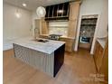 Stylish kitchen with custom island, granite countertops, hardwood floors and modern stainless appliances at 1721 S New Hope Rd, Gastonia, NC 28054