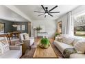 Living room and dining room featuring hardwood floors, large windows, modern furnishings, and natural light at 2232 Glenraven Ave, Gastonia, NC 28052