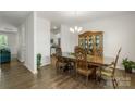 Elegant dining room featuring a classic wooden dining set, chandelier lighting and wood floors at 2527 Linhay Dr, Charlotte, NC 28216