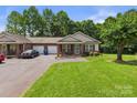 Inviting brick townhome featuring an attached garage, a cozy front porch, and a well-maintained lawn at 2541 26Th Ne Ave, Hickory, NC 28601
