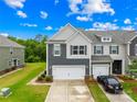 Charming townhome with a two-car garage and manicured lawn on a sunny day at 2717 Aubrey St, Monroe, NC 28110