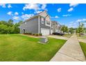Inviting two-story townhome showcasing a well-kept lawn and a convenient two-car garage at 2717 Aubrey St, Monroe, NC 28110