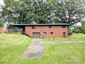 Brick house with a back deck, a full basement, and an expansive lawn at 3115 Falling Creek Rd, Hickory, NC 28601