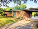 All brick home with covered front entry and carport offering a welcoming approach at 3115 Falling Creek Rd, Hickory, NC 28601
