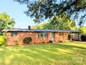 Charming brick home featuring a covered carport and well-maintained lawn enhancing its inviting appeal at 3115 Falling Creek Rd, Hickory, NC 28601