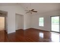Bright, empty living room with hardwood floors, white walls, and a ceiling fan at 328 Burrage Ne Rd, Concord, NC 28025