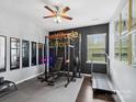 Home gym with weights, pull-up rack, and a treadmill on rubber flooring at 417 Livingston Dr, Lancaster, SC 29720
