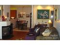 Inviting living room with fireplace, hardwood floors, and seamless transition to a cozy dining area at 4492 Antelope Ln, Charlotte, NC 28269