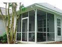 Enclosed porch offers a cozy, bright space with multiple windows for natural light and comfortable outdoor living at 4492 Antelope Ln, Charlotte, NC 28269