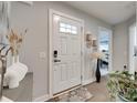 Welcoming foyer with a stylish front door, elegant decor, and hardwood floors at 4511 Hunton Dale Nw Rd, Concord, NC 28027