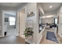 Hallway featuring hardwood floors, decorative wall accents, and an open view into the living room at 4511 Hunton Dale Nw Rd, Concord, NC 28027