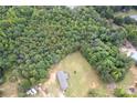 Aerial view of house with dense trees showcasing the property's private, wooded surroundings at 4630 Irish Potato Rd, Kannapolis, NC 28083