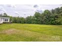 Expansive backyard with ample green space and mature trees creating a serene and private setting at 4630 Irish Potato Rd, Kannapolis, NC 28083