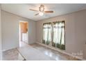 Cozy bedroom featuring light-filled windows and a ceiling fan for added comfort and ventilation at 4630 Irish Potato Rd, Kannapolis, NC 28083