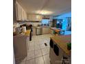 Functional kitchen with white cabinets, stainless steel appliances, and tiled floor at 5022 Wrenn Dr, Denver, NC 28037